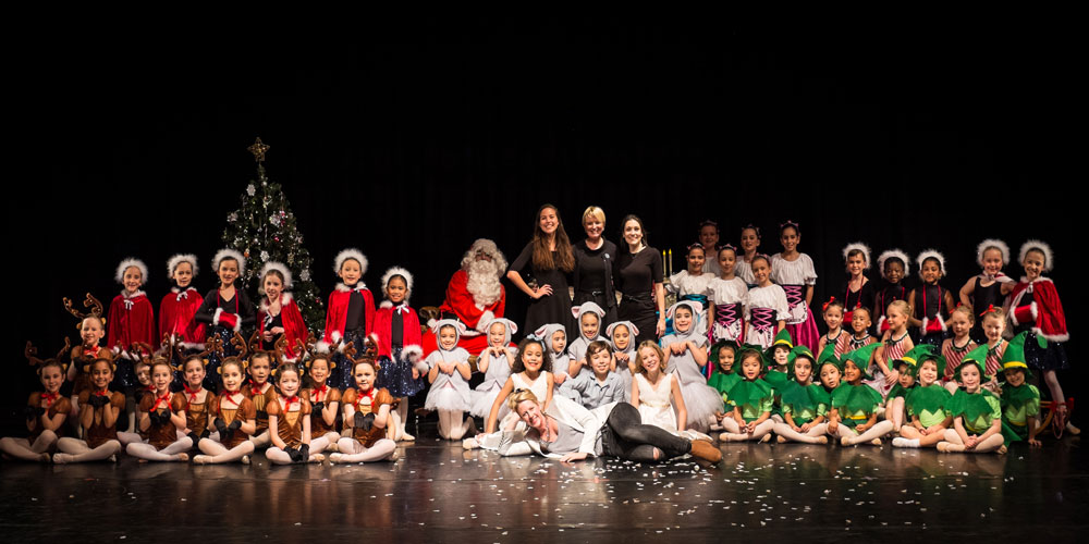 20+ children sat on stage in costumes