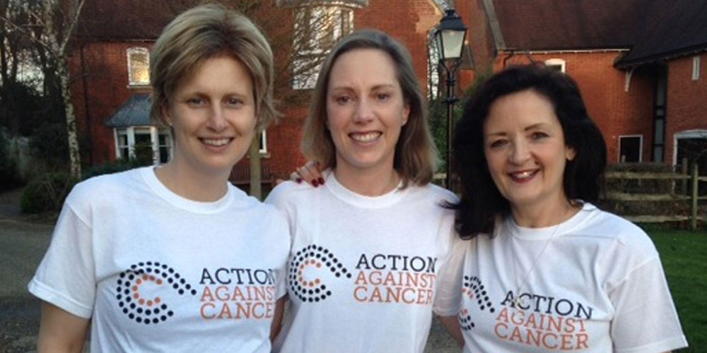 Photo of 3 ladies smiling in AAc t-shirts